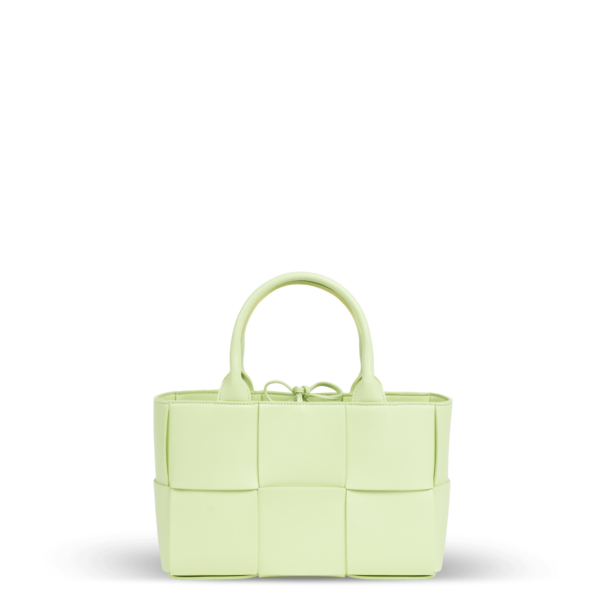 A small light green leather handbag in a braided pattern from the Bottega Veneta brand.