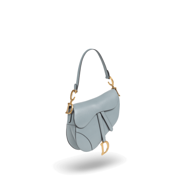 A light blue handbag with gold hardware from the Dior brand.